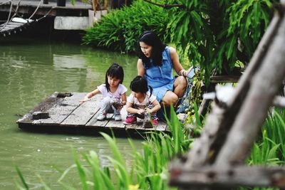 Full length of children on water at plants