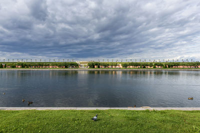 Scenic view of lake against cloudy sky