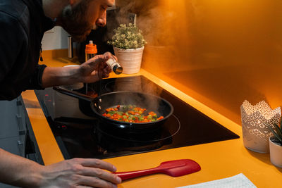 Cropped hands preparing food on table