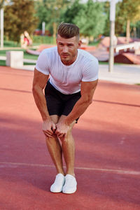 Full length of woman exercising on court