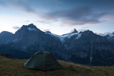 Scenic view of mountains against cloudy sky