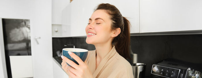 Young woman using mobile phone at home