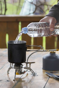 Close-up of hand pouring drink in glass