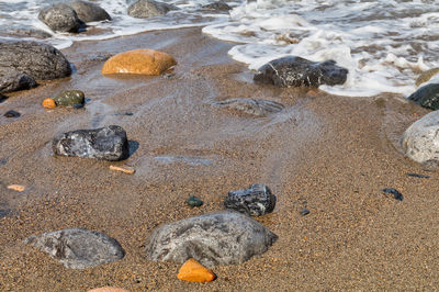 High angle view of pebbles on beach