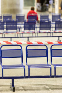 Stretched protective red tape on chairs. it is forbidden to sit on public seats.