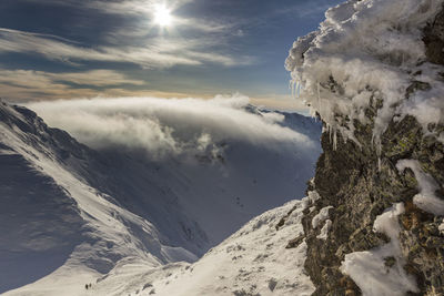 Scenic view of snow covered mountains against sky