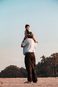 Full length of man standing on land against clear sky