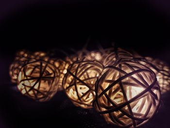 Close-up of illuminated lighting equipment against black background