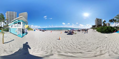 People on beach against sky