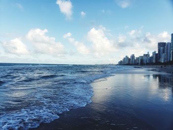 Scenic view of sea against sky in city