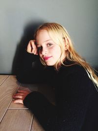 Portrait of young woman sitting at home