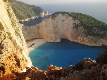 High angle view of rocks by sea against sky