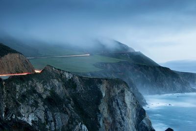 Scenic view of rocky cliffs next to sea