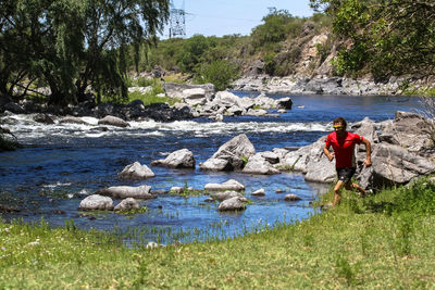 People on rocks by river