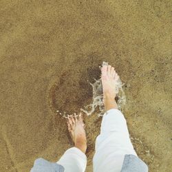 Low section of woman standing on beach