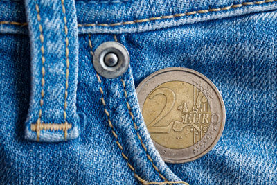 Close-up of coin in jeans pocket