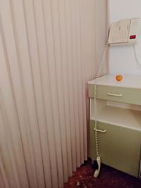 Close-up of empty table against wall at home