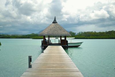 Pier over lake against sky