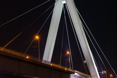 Low angle view of illuminated bridge against sky at night