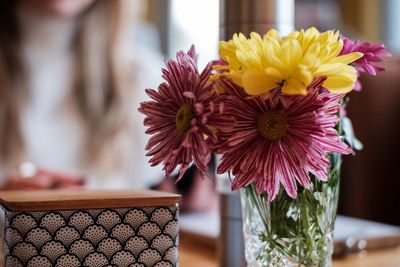 Close-up of flower vase on table in cafe