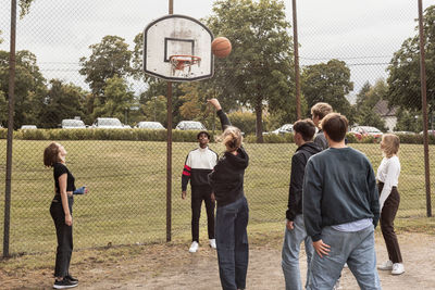 Teenagers playing basketball