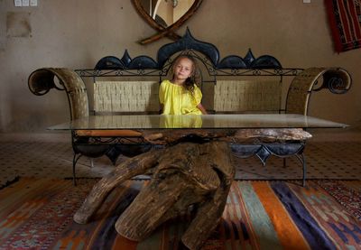 Portrait of young woman sitting at home