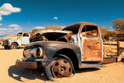 Old rusty car against sky