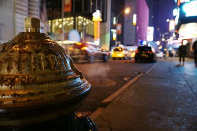 Rusty fire hydrant on city street at night