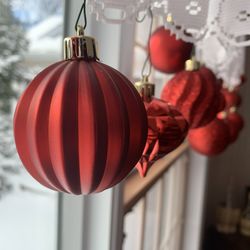 Close-up of red lanterns hanging on metal at home