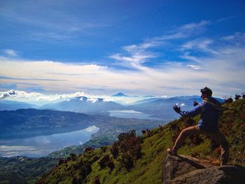 Man action on mountain against sky