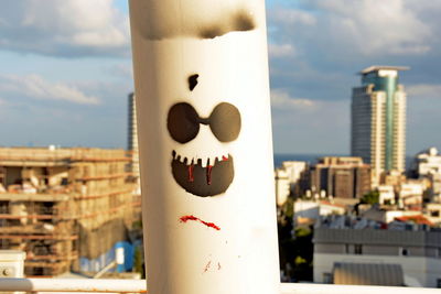 Close-up of clock tower against buildings in city