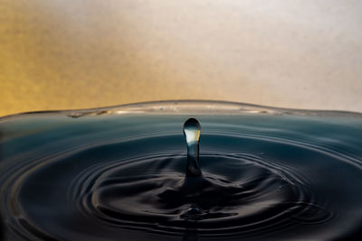 Close-up of drop falling on water