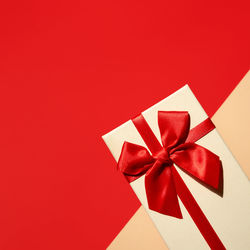 Low angle view of christmas decoration against red background