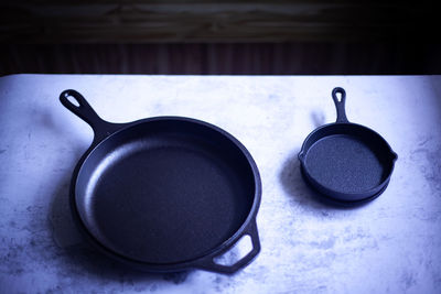 High angle view of small frying pans on table