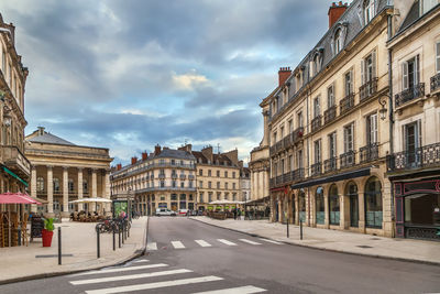 City street amidst buildings against sky