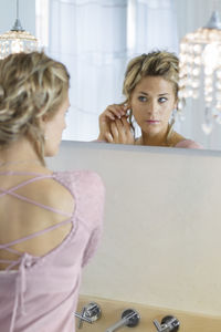 Portrait of young woman in bathroom