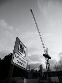 Low angle view of information sign against sky