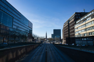 Road amidst buildings against sky in city