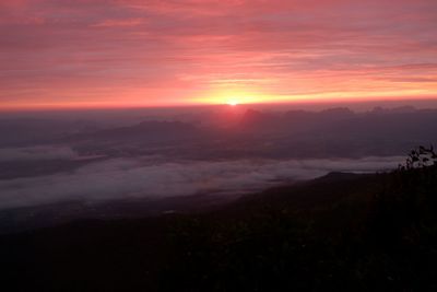 Scenic view of landscape against romantic sky at sunset