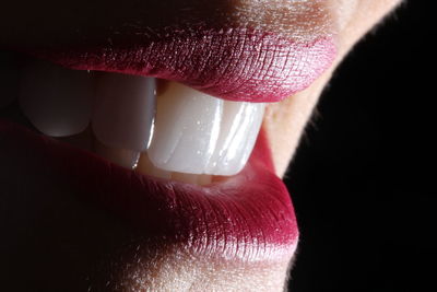 Close-up of woman on black background