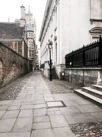 Walkway in city against sky