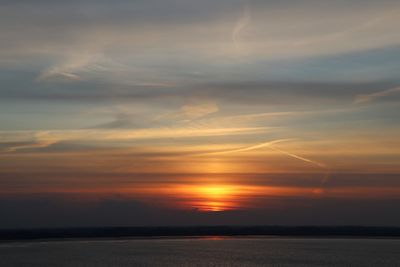 Scenic view of sea against romantic sky at sunset