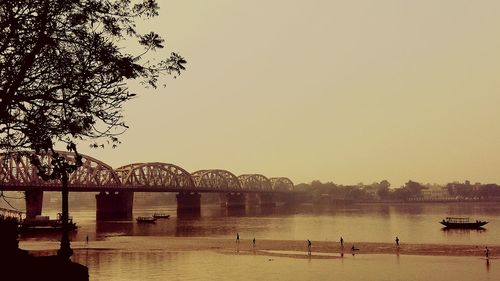 Bridge over river at sunset