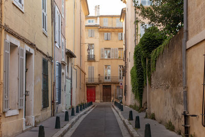 Old buildings along narrow alley in france