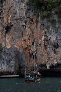 People on rock by sea