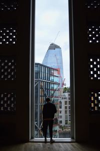 Rear view of man in office building