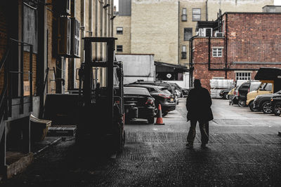 Rear view of man standing in city