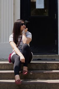 Full length of woman standing on bench