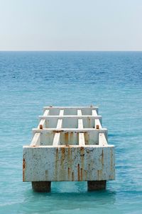 Built structure by sea against clear sky