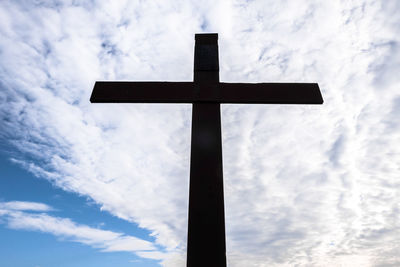 Low angle view of cross against sky